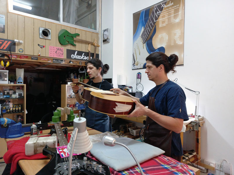 George and Khatch fixing a guitar