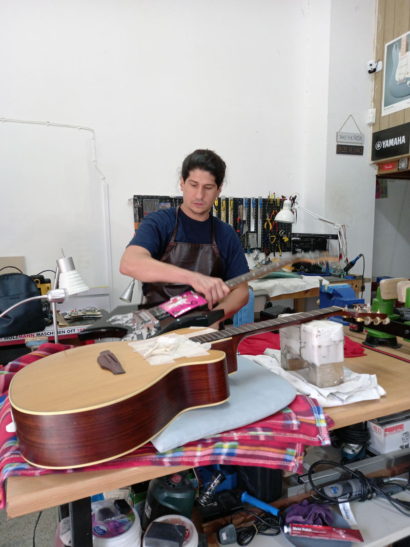 George working on guitar